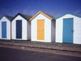 Preston Sands famous multicoloured beach huts close to family beach with safe swimming & water sports